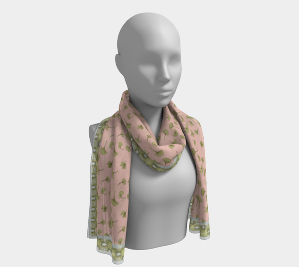 Long silk scarf worn wrapped loosely around the neck .